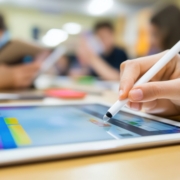 Student Using Tablet and Stylus in Classroom